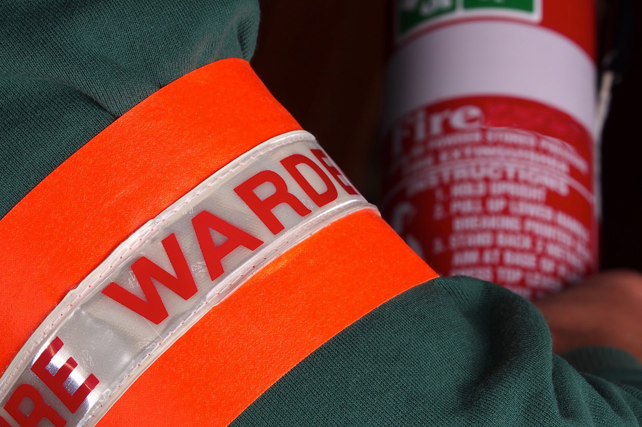 fire warden holding fire extinguisher